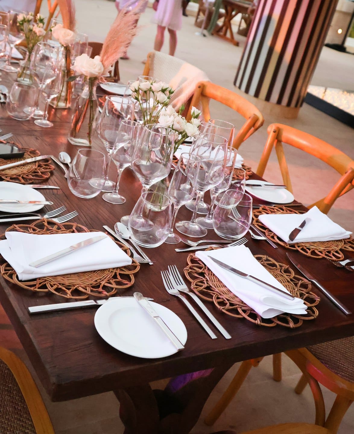Elegant dining table set with place settings and floral centerpieces.